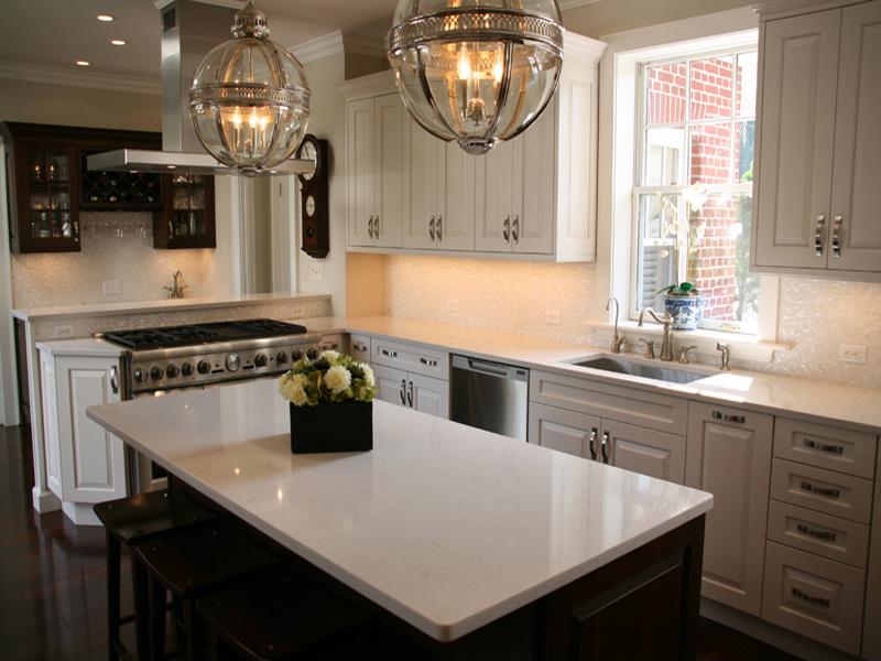 The use of neutral colors like beige and tan really enhances the look of the white cabinets. 