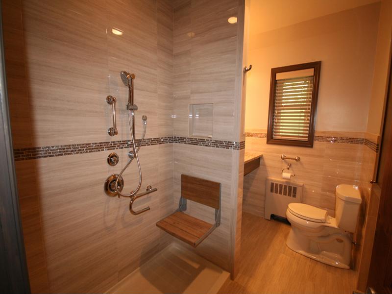 Adding a chair to the shower, along with handle bars and low plumbing fixtures, can make it more accessible for all family members. 