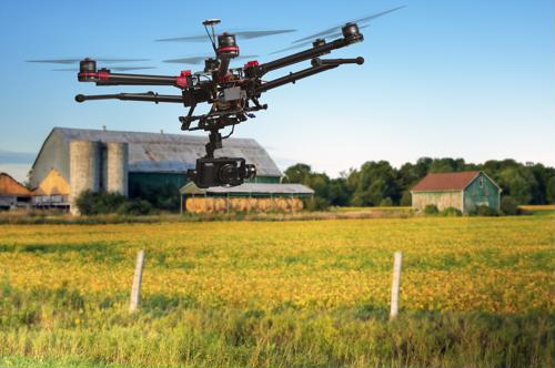 A flying drone on farm land. 