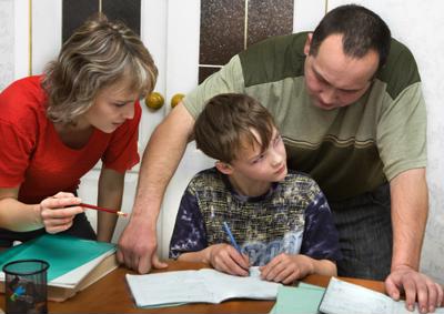 Parents helping their student with homework.