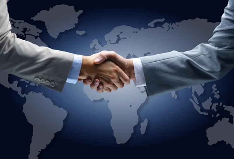 A handshake on a world map.