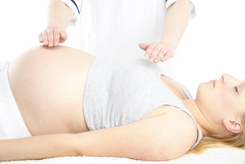 A pregnant woman getting a massage.
