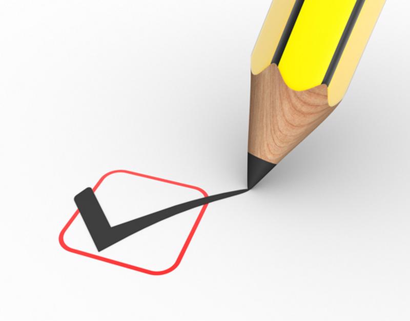 A pencil checks off a checklist item.