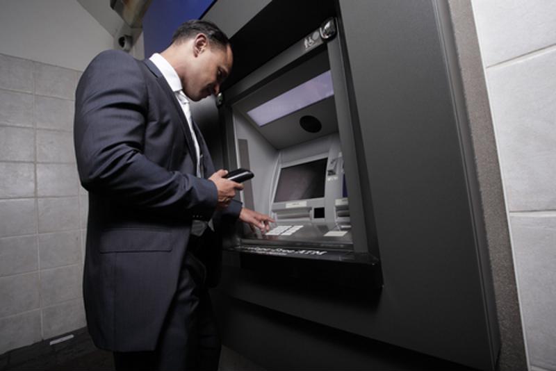 A man using an ATM.