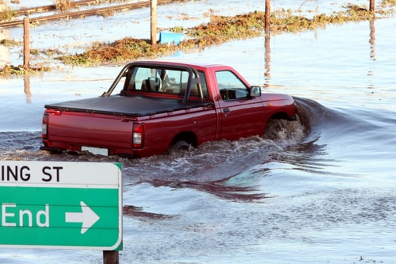 A car gets caught in a flood.