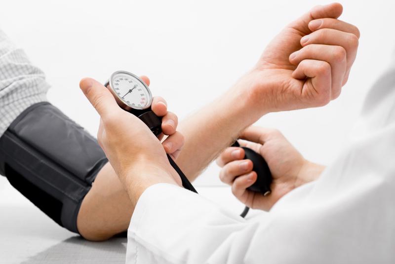 Doctor measuring blood pressure. 