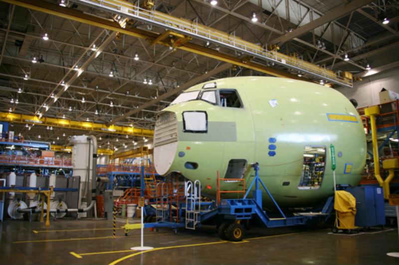 Partially-built plane in a factory.