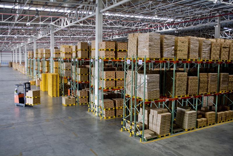 A warehouse floor is filled with a racking system storing pallets.