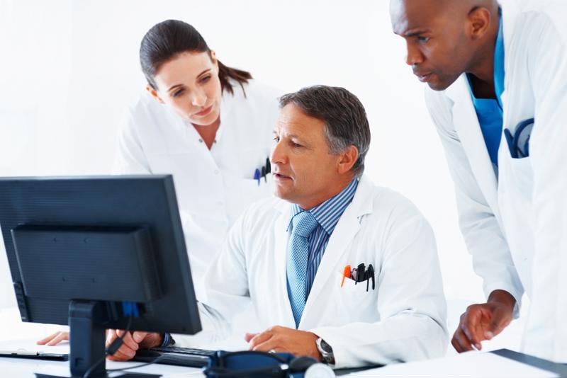 Medical staff around a computer