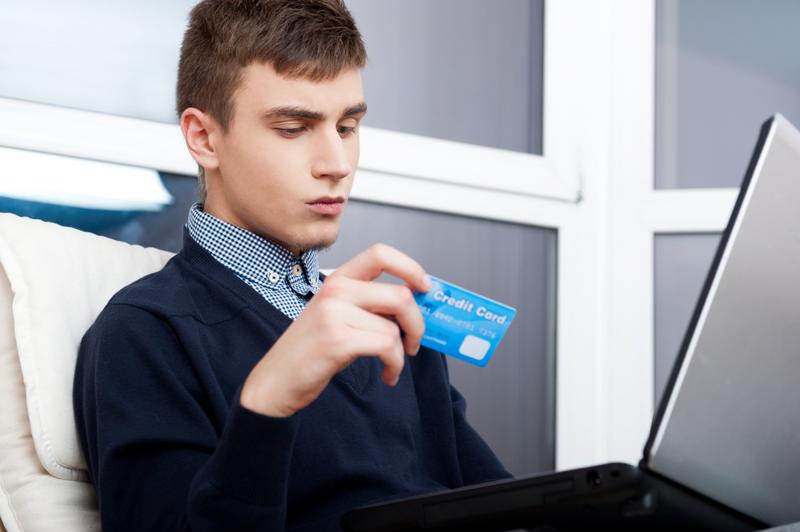Young man makes a purchase online.