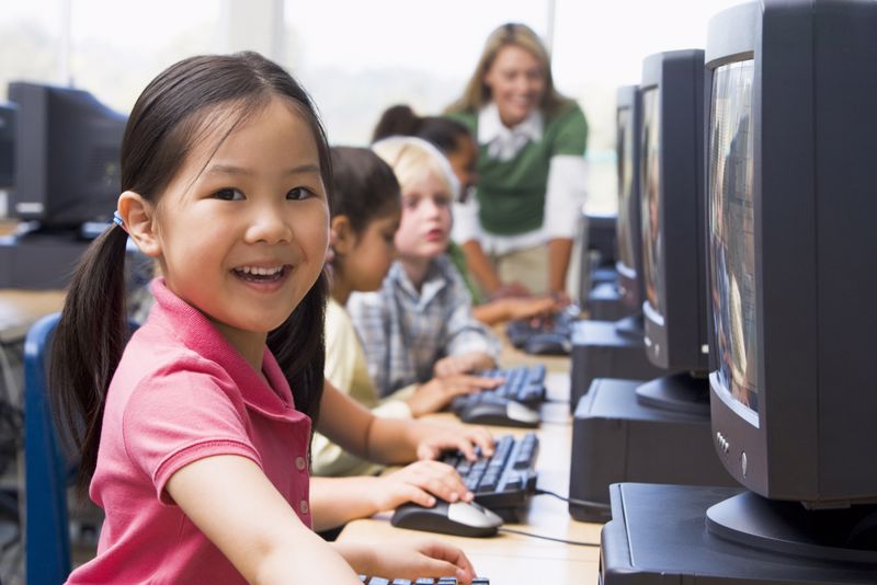 Students and teacher using laptops 