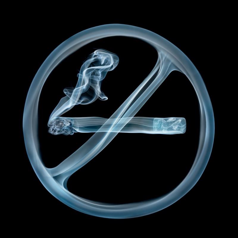 Sign made of smoke crossing out cigarette.