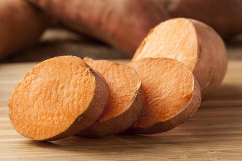 Sliced sweet potatoes sit on a table