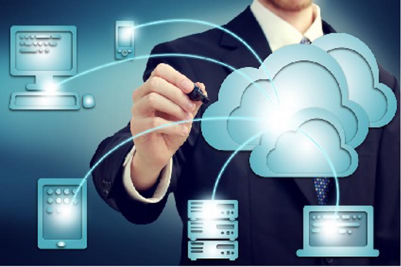 Man holding pen connecting different devices to a cloud.