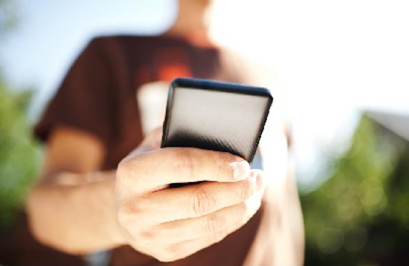 Man opening text message on his phone.