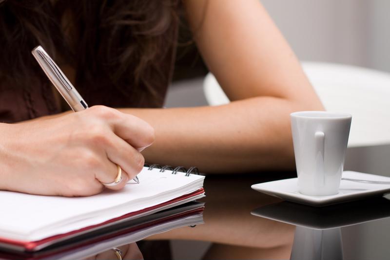 woman writing on paper