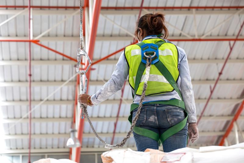 Worker wearing safety harness.