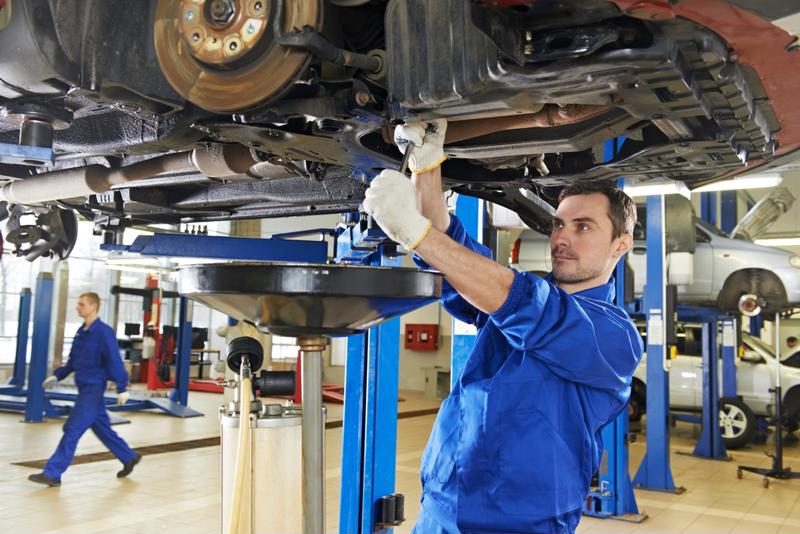 A technician works on a car.