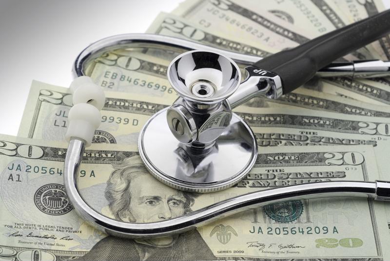 Stethoscope on twenty-dollar bills. 