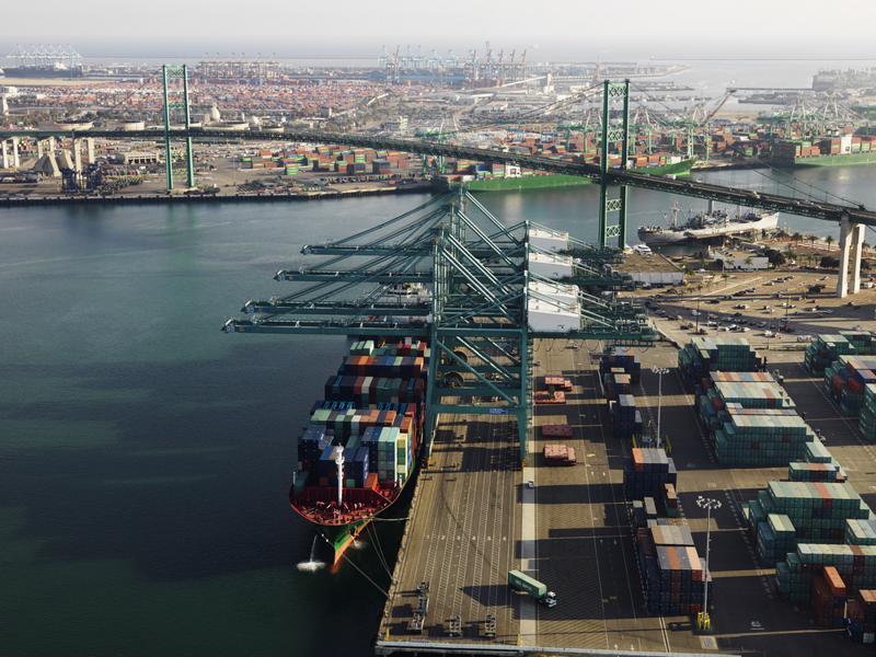 A cargo ship unloads in a port.