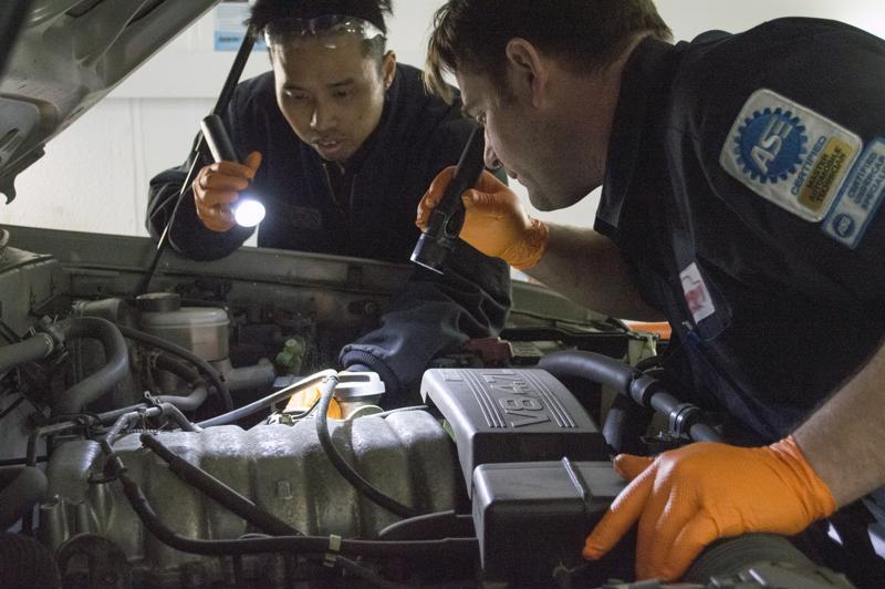 Mechanics assess the damage with an electronic scan tool. 