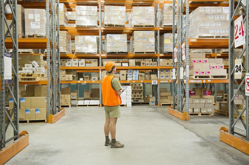 Warehouse worker taking  inventory.