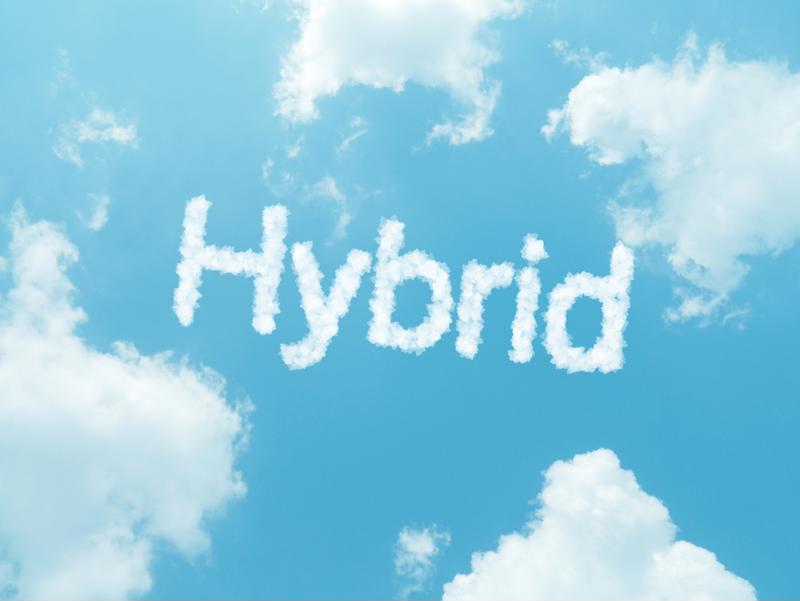 clouds surrounding the word "Hybrid" as a cloud, to represent hybrid cloud computing