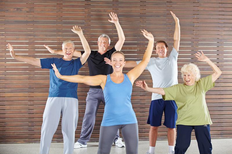 Physical therapist leads senior dance class.