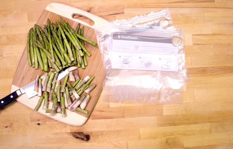 Produce like fresh asparagus should be vacuum sealed and stored toward the top of the fridge.