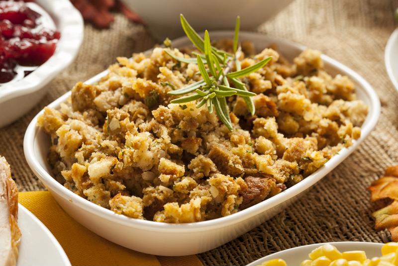 A bowl of cornbread stuffing sits on a table