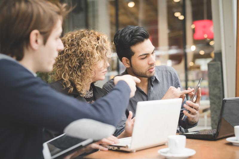 A group of startup employees holding a meeting in a conference room.