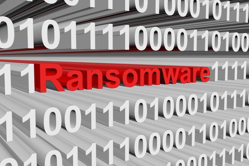 "Ransomware" in red among white and grey zeros and ones. 