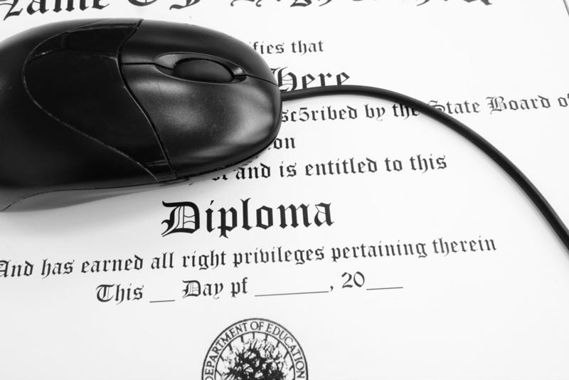 Computer mouse on top of diploma. 
