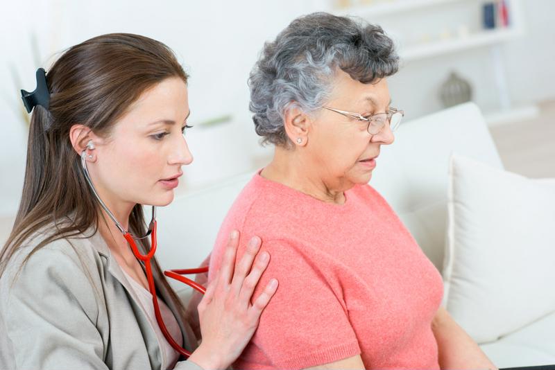 Doctor checking patient's back.