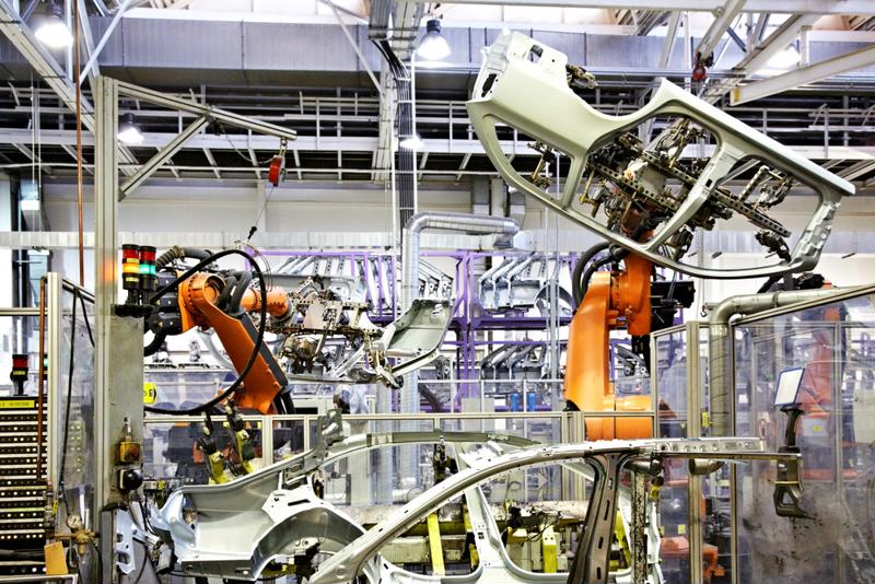 Cars being manufactured in a factory.
