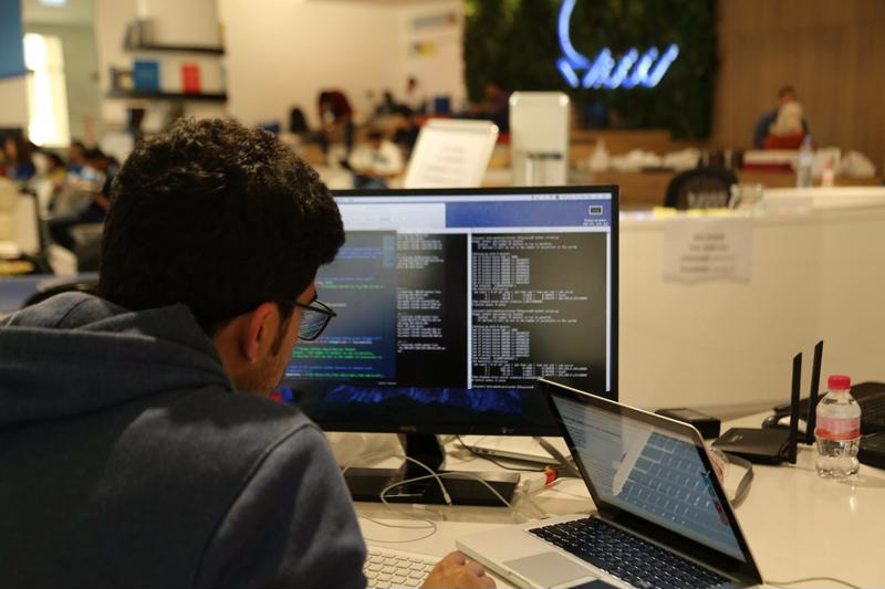 person coding at their computer, using multiple terminals