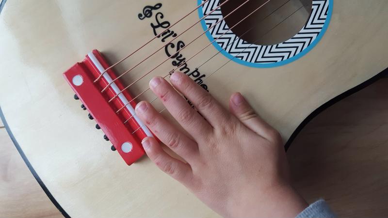 This photo was taken the morning after my two-year-old received his first guitar. Note the cuts on his fingers!