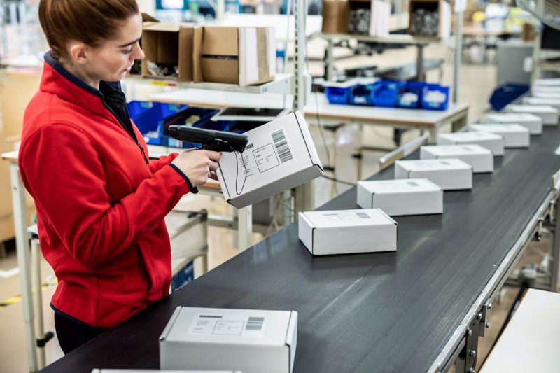 A warehouse working scanning a product's barcode.