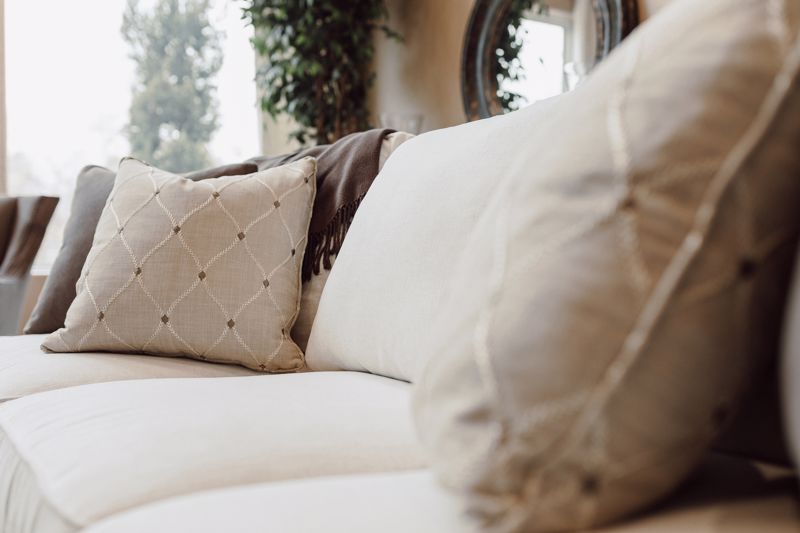 By keeping your sofa's accessories neutral-toned, you can swap bright pieces in and out throughout the year.