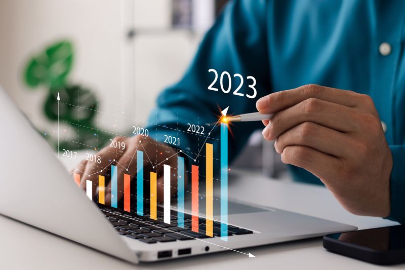 Business person with laptop displaying a growth chart. 