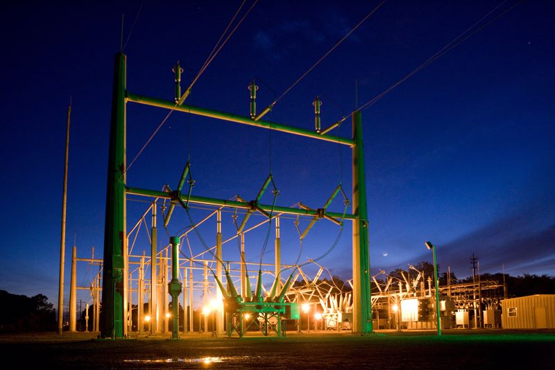 A large energy substation at night time.