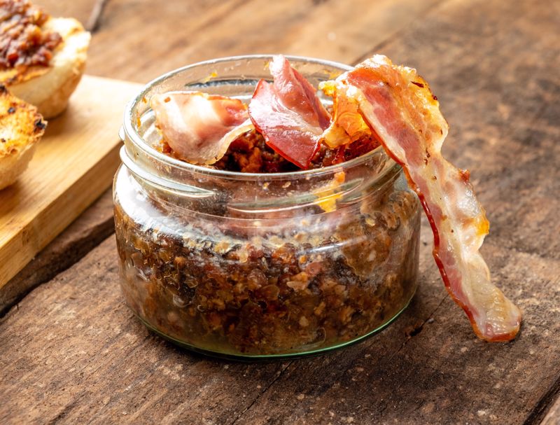 A close-up photo of a jar of tomato bacon jam 