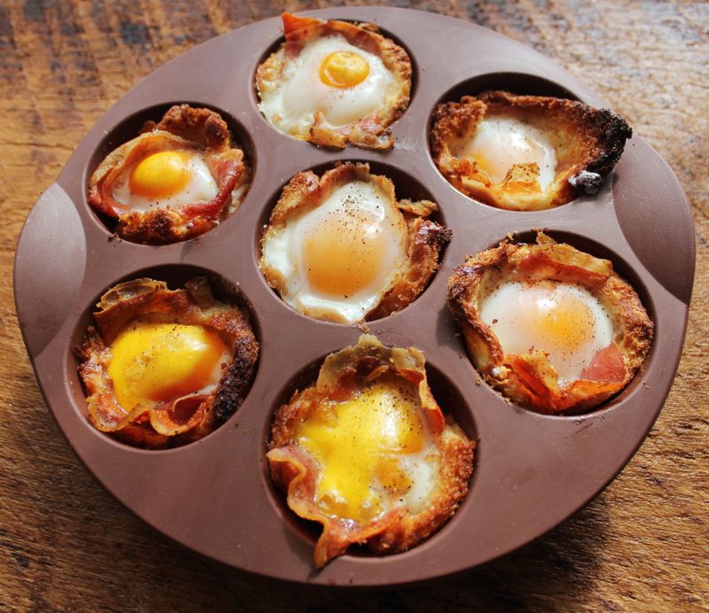 Bacon egg cups sit in a muffin pan